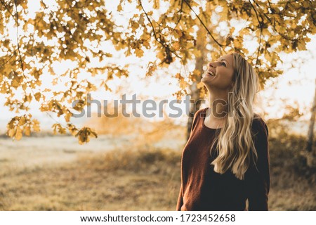 Blonde woman enjoys the autumn Royalty-Free Stock Photo #1723452658