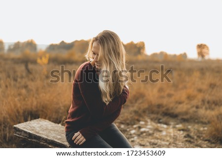 Blonde woman enjoys the autumn Royalty-Free Stock Photo #1723453609