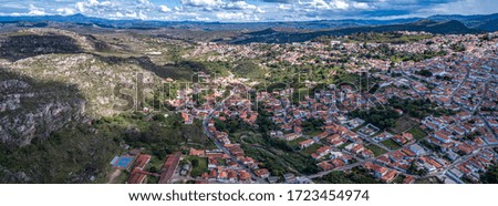 Panoramic aerial view with sunshine, shadow, cloudy sky of the east part of historic town Diamantina and valley, Minas Gerais, Brazil