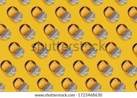 Full Pringles Tube, top view on a yellow background, top view. Food pattern Royalty-Free Stock Photo #1723468630