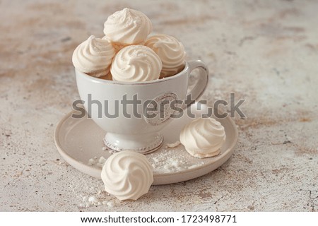 French dessert Meringue prepared from whipped with sugar and baked eggs.A cup of home-made meringues 