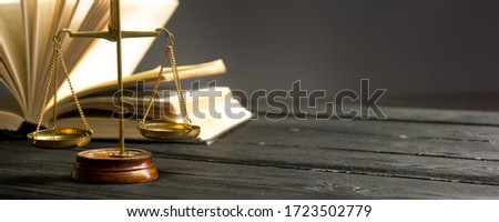 Law concept - Open law book with a wooden judges gavel on table in a courtroom or law enforcement office isolated on white background. Copy space for text Royalty-Free Stock Photo #1723502779