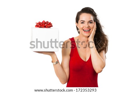 A beautiful happy surprised woman in a red dress smiling and holding a big white gift box. Isolated on white.