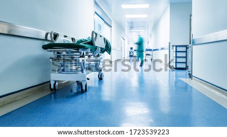 Doctors or nurses walking in hospital hallway, blurred motion. Royalty-Free Stock Photo #1723539223