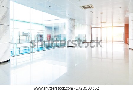 Empty long corridor in modern office building. Royalty-Free Stock Photo #1723539352