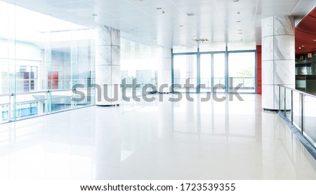 Empty long corridor in modern office building. Royalty-Free Stock Photo #1723539355