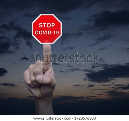 Hand pressing stop COVID-19 outbreak flat icon over sunset sky, Global epidemic alert, Concept of novel coronavirus outbreak