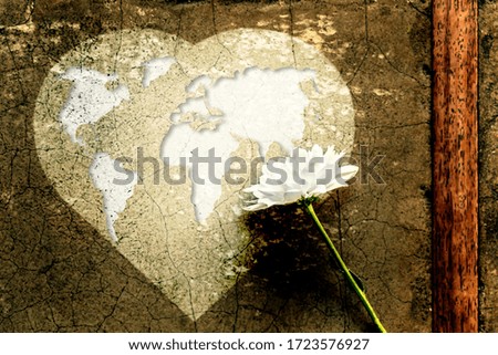 Give Love and Care for everyone on Earth concept, White Flower on World map in Dark Heart Blurred Grunge Background,