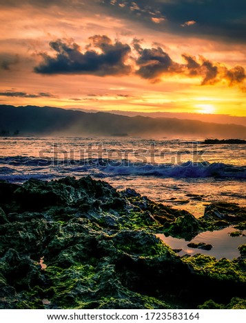 Sunset with ocean ocean waves at Haleiwa beach in north shore of Oahu island , Hawaii, USA 
