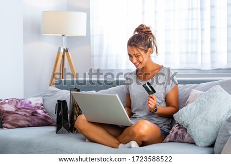 Picture showing pretty woman shopping online with credit card. woman holding credit card and using laptop. Online shopping concept