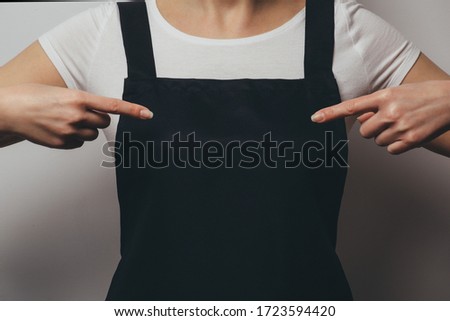 Woman in apron pointing fingers into chest. Bakery, chef, cook or waiter concept mockup
