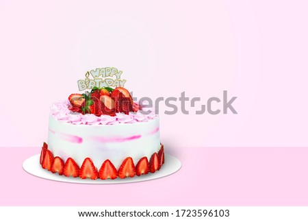 Strawberry birthday cake over pink background.