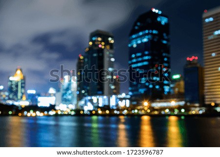 Abstract of colorful bokeh light  background with building of bangkok