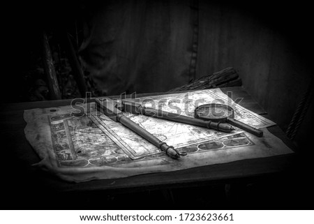 Old pirate house. Table and various fruits. Black and white