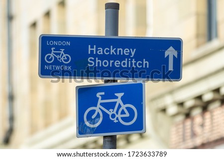 A cycle route sign in central London directs bike riders towards Hackney and Shoreditch along the cycle network Royalty-Free Stock Photo #1723633789