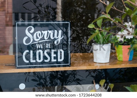 Sorry we're closed sign. grunge image hanging on a  windows
