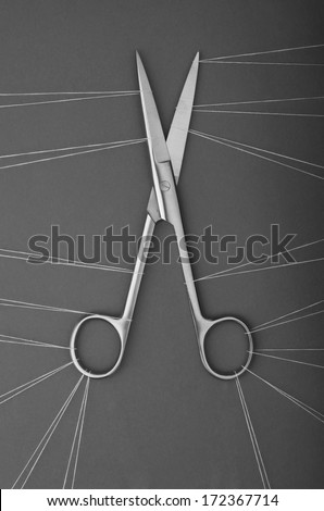 The power of many. Many threads capturing scissors symbolizing the power of unity