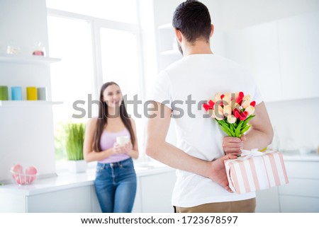 Back rear spine photo of man close cover blossom bunch tulips striped gift box package dream he prepare sweetheart 14-february 8-march holiday stay home in kitchen house indoors