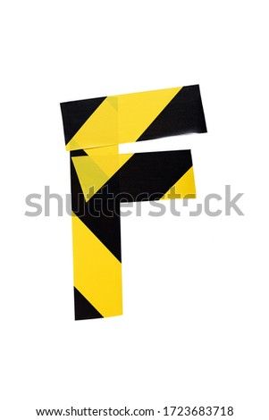 Letter F from yellow and black warning tape isolated on white background. Caution lines. Danger and risk sticky tape. Police stripe line. Industrial protection