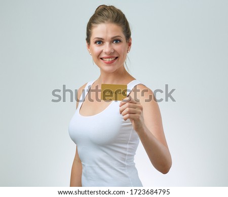 Smiling woman in white singlet top holding card. Sport Training abonnement concept with female portrait.