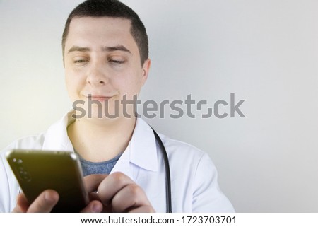 The doctor is holding a smartphone. Medical consultation by phone. Mobile app for healthcare providers