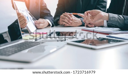 Cropped shot group of businesspeople using graph chart and computer laptop, tablet discussing about business plan together in modern office. Royalty-Free Stock Photo #1723716979