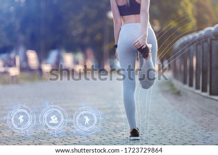 Girl does warm-up before jogging with smart watches. Functions swimming, warming up, strength exercises Royalty-Free Stock Photo #1723729864