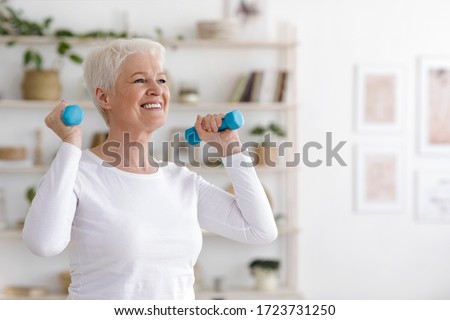 Healthy Lifestyle. Smiling Senior Lady Exercising With Dumbbells At Home, Free Space Royalty-Free Stock Photo #1723731250