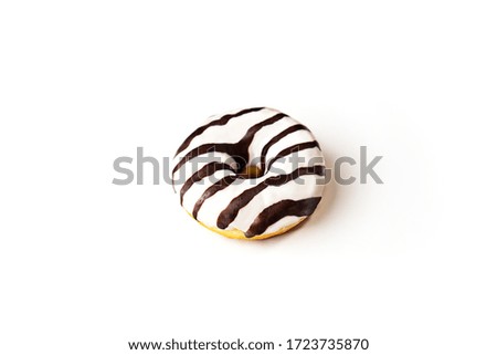 Glazed striped donut on white background, isolated. Party food concept with copy space. Top view.