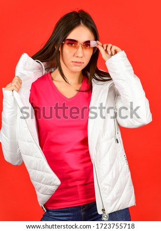 Keep calm and wear cool glasses. Cute Pretty girl hood jacket red background. Fashion has to reflect who you are. Woman enjoy spring weather. Woman fashion model. Fashion outfit. Pink eyeglasses.
