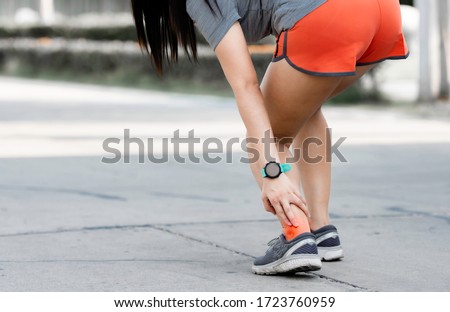 Achilles tendon tearing, a common running injury. pressure point. achilles tendon painful. Royalty-Free Stock Photo #1723760959