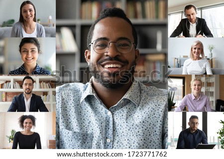 Smiling african American male employee talk speak on video call with multiracial work colleagues, diverse businesspeople coworkers have online webcam conference on computer, engaged in web briefing