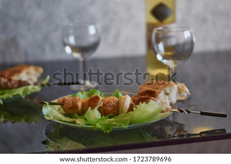Plate with barbecue and a bottle of wine. Dinner for two