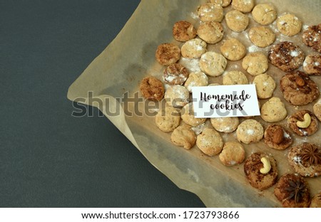 A card with the inscription Homemade Cookies on the background of homemade cookies. The comfort of home, traditional home shortbread cookies with nuts, cane sugar and cocoa