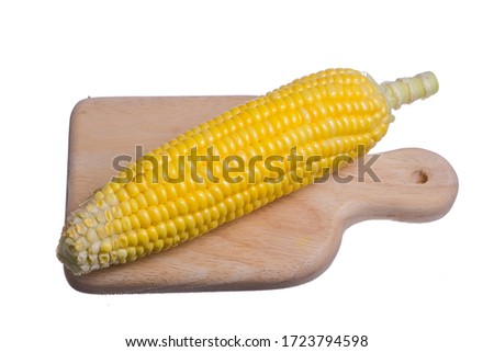Fresh corn with wooden cutting board  isolated on white background.