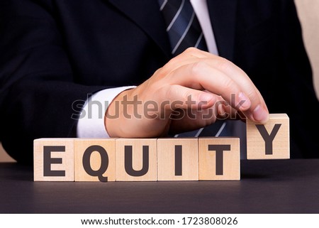 Man made word Equity with wooden blocks. Business concept.