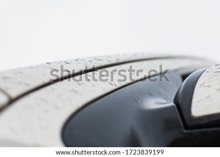 Fragment of a car element with water drops after rain