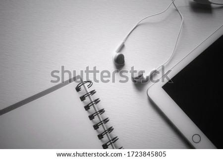 Small Talk for connecting to a smartphone or tablet placed together with a notebook placed near  The gray tone image is used as a background in the "work at home" concept.