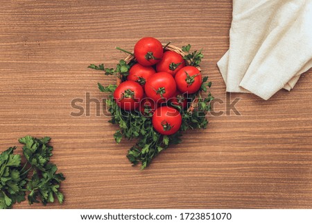 basket of tomatoes on wooden table with tissue