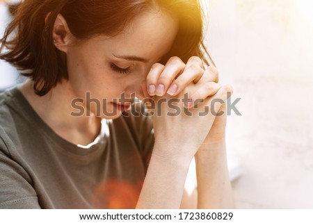 Cute beautiful girl folded her hands in prayer. A woman asks God for help Royalty-Free Stock Photo #1723860829