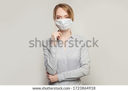 Optimistic woman in protective mask on white background