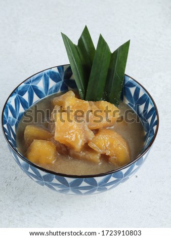 Selective focus of Kolak singkong is an Indonesian dessert made from cassava cooked with coconut milk, palm sugar and pandan leaves. Very popular during Ramadhan.