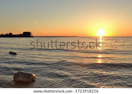Bright picturesque golden sunset on a summer evening at Rybinsky Reservoir