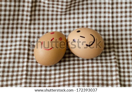 smile love egg couple in brown kitchen towel on wood table