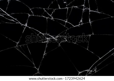 Broken black glass, with white lines on black glass.