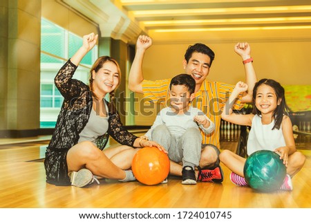 Asian family activity concept : Family team were happy after the bowling together for fun on the weekends.
