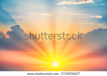 Sunset with sun and clouds on blue and orange dramatic sky with sun rays Royalty-Free Stock Photo #1724058607