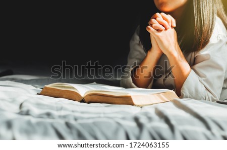 Young woman reading the holy bible in morning, worship and pray.devotion concept. Royalty-Free Stock Photo #1724063155