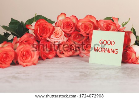 pink rosses with good morning text on desk