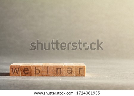 online business inscription engraved on blocks that hold fingers on a gray background. webinar
